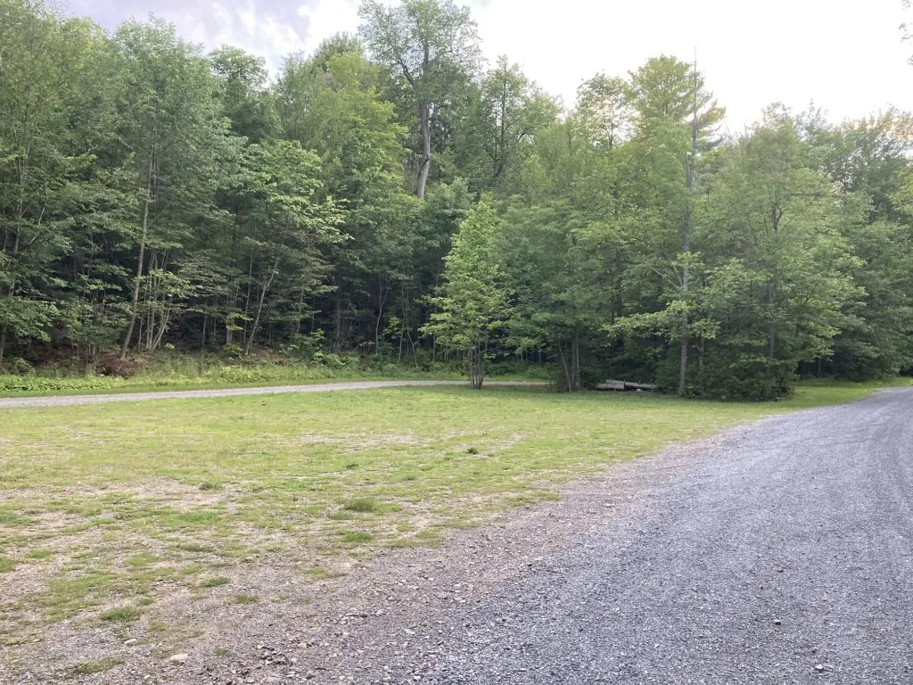 The grassy parking area for Lake of the Woods NY fishing and public boat launch