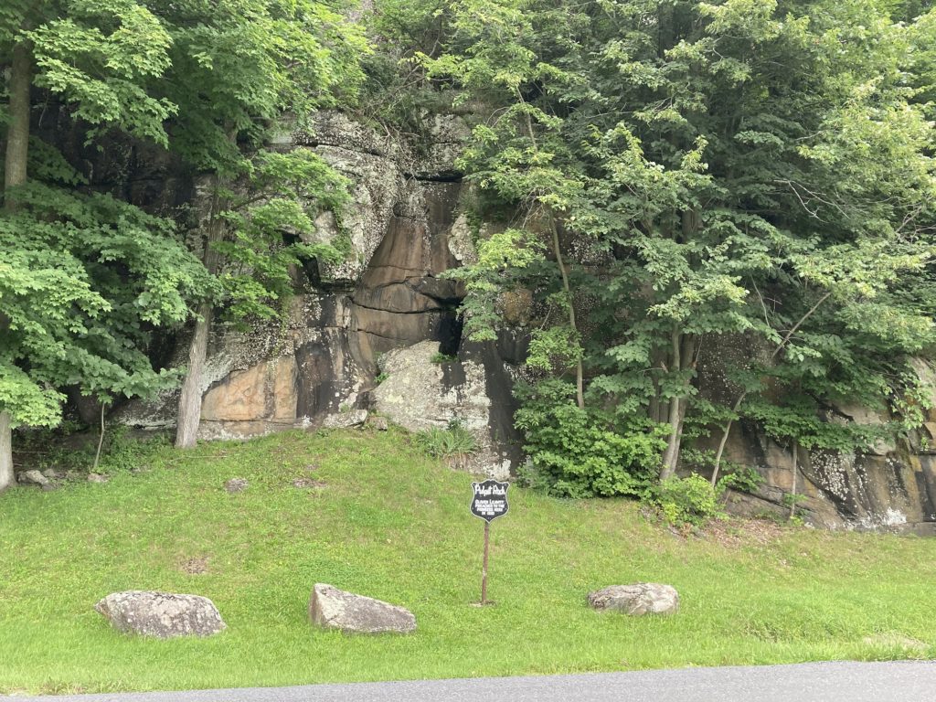 Pulpit Rock from the other side of the road for a view of the parking area and rock formation, as well as the interpretive sign