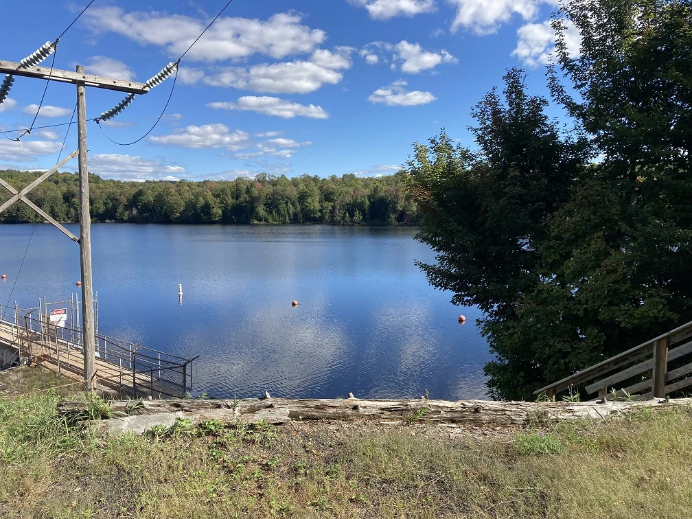 Photograph of the water and shore at the dam at the Oswegatchie River at the Flat Rock Picnic area