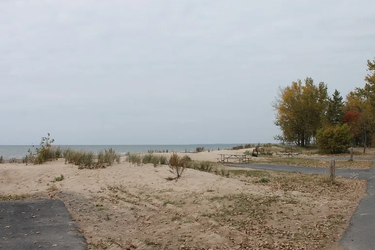 Sandy beach-side campsites at Southwick Beach with Lake Ontario in the background