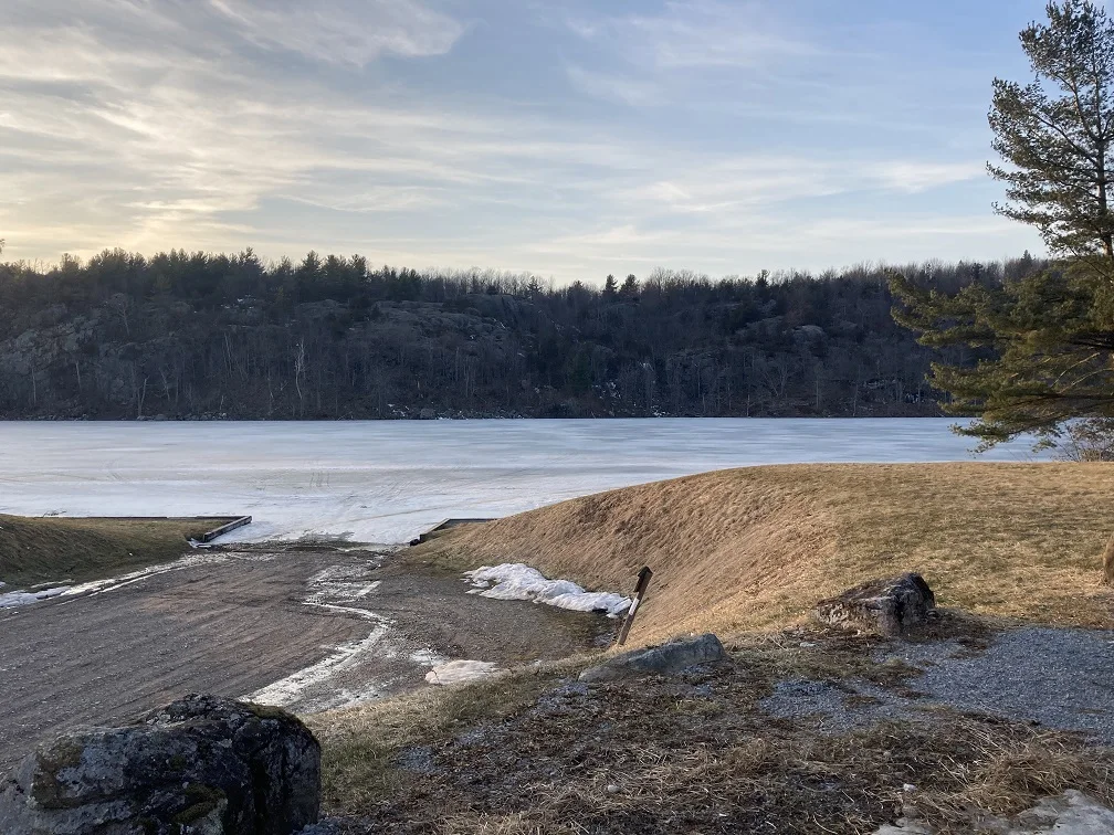 A photograph of Payne Lake taken in mid-March a few years ago, the lake is still pretty frozen.  The photo is taken from up high at the parking area at the boat launch